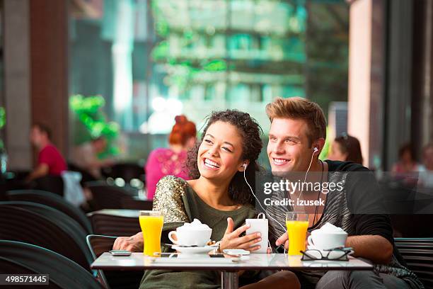 urban young people in cafe - mp3 juices stock pictures, royalty-free photos & images
