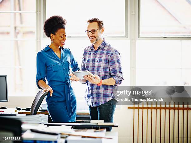 smiling coworkers discussing project in office - woman making a deal stock pictures, royalty-free photos & images