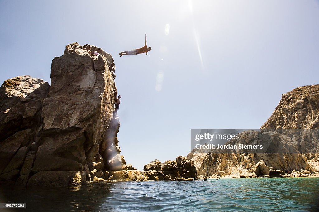 A man diving off a cliff.