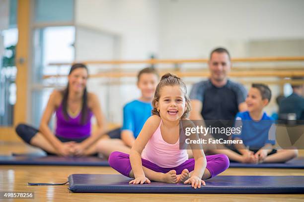 little girl doing yoga with her family - kids in undies stock pictures, royalty-free photos & images