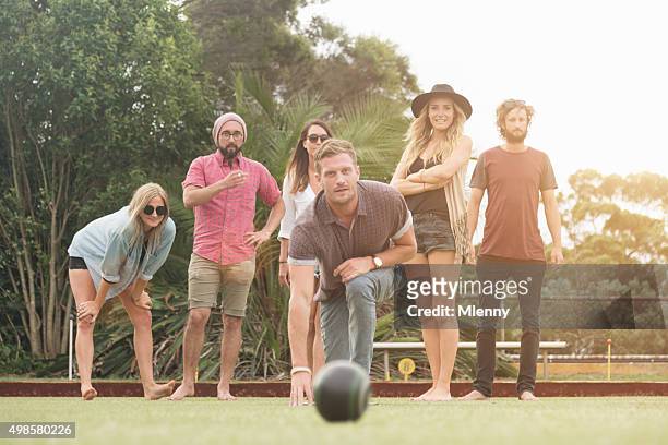 australian friends enjoy playing lawn bowling - bowling party stock pictures, royalty-free photos & images