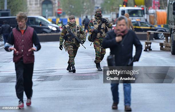 Belgian security forces patrol in streets, in Brussels where all stores had to close following the terror alert level being elevated to 4, in...
