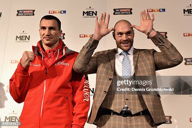 Tyson Fury jokes next to Wladimir Klitschko as they have their stare off during a press conference at Rheinterassen on November 24, 2015 in...