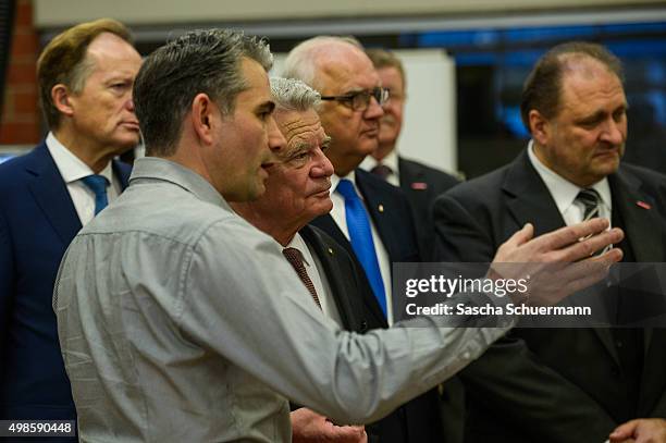 German President Joachim Gauck meets a Turkish descent teacher at a the Vocational training center of the Chamber of Crafts on November 24, 2015 in...