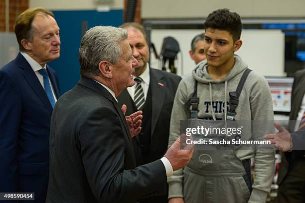 German President Joachim Gauck meets trainees and teacher at a the Vocational training center of the Chamber of Crafts on November 24, 2015 in...