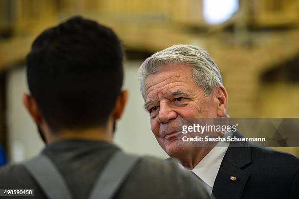 German President Joachim Gauck meets a trainee at the Vocational training center of the Chamber of Crafts on November 24, 2015 in Cologne, Germany....