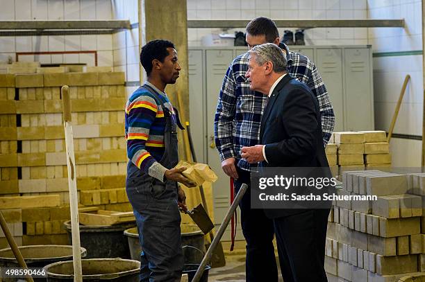 German President Joachim Gauck meets trainees and teacher at a the Vocational training center of the Chamber of Crafts on November 24, 2015 in...