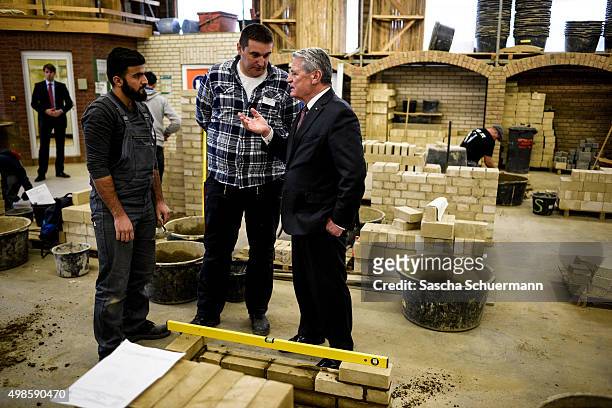 German President Joachim Gauck meets trainees and teacher at a the Vocational training center of the Chamber of Crafts on November 24, 2015 in...