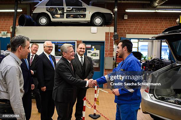 German President Joachim Gauck meets trainees and teacher at a the Vocational training center of the Chamber of Crafts on November 24, 2015 in...