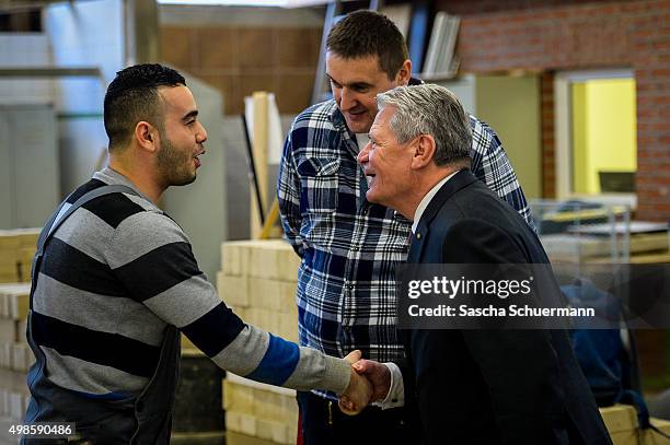 German President Joachim Gauck meets trainees and teacher at a the Vocational training center of the Chamber of Crafts on November 24, 2015 in...