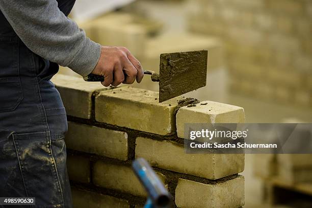 Students with an immigrant background working as a bricklayer at the Vocational training center of the Chamber of Crafts on November 24, 2015 in...