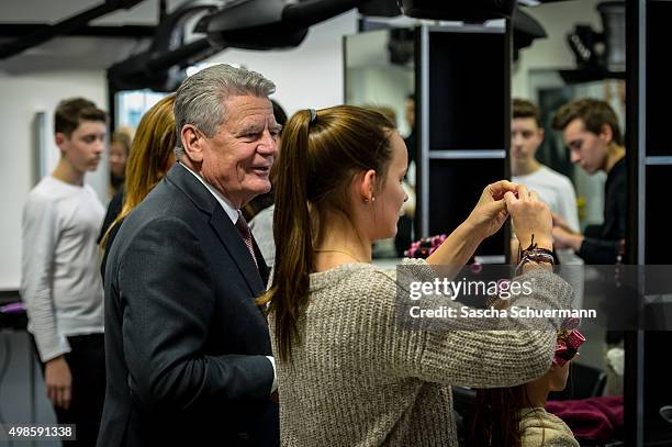 German President Joachim Gauck meets trainees working as a hairdresser with a dummy at the Vocational training center of the Chamber of Crafts on...