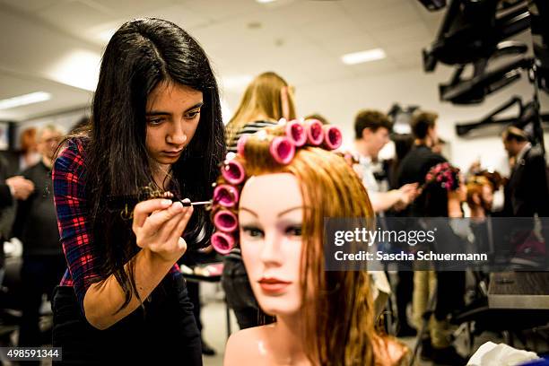 Students with an immigrant background working as a hairdresser with a dummy at the Vocational training center of the Chamber of Crafts on November...