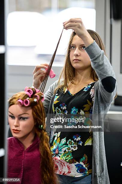 Student working as a hairdresser with a dummy at the Vocational training center of the Chamber of Crafts on November 24, 2015 in Cologne, Germany....