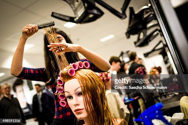Students with an immigrant background working as a hairdresser with a dummy at the Vocational training center of the Chamber of Crafts on November...