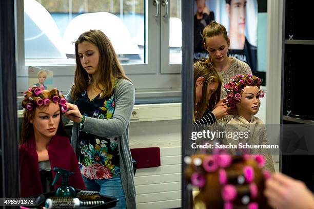 Student working as a hairdresser with a dummy at the Vocational training center of the Chamber of Crafts on November 24, 2015 in Cologne, Germany....