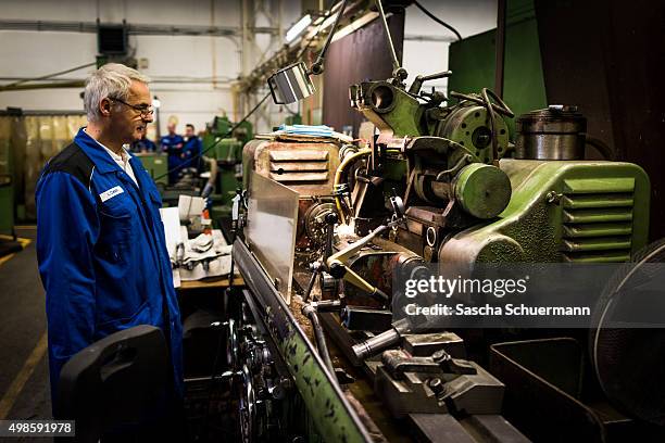Man at work during the German President Joachim Gauck's visit to meet trainees at a job training facility at W. Eubel GmbH machine manufacturer on...
