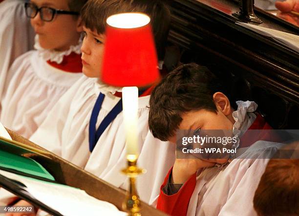 Choirboy sits in the pews during a service for the Inauguration Of The Tenth General Synod at Westminster Abbey on November 24, 2015 in London,...