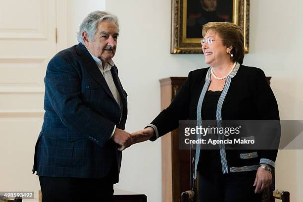 Former President of Uruguay Jose Mujica greets President of Chile Michelle Bachelet at Palacio de la Moneda on November 24, 2015 in Santiago, Chile.