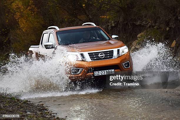 nissan np300 navara in a river - sports-utility-vehicle stock pictures, royalty-free photos & images