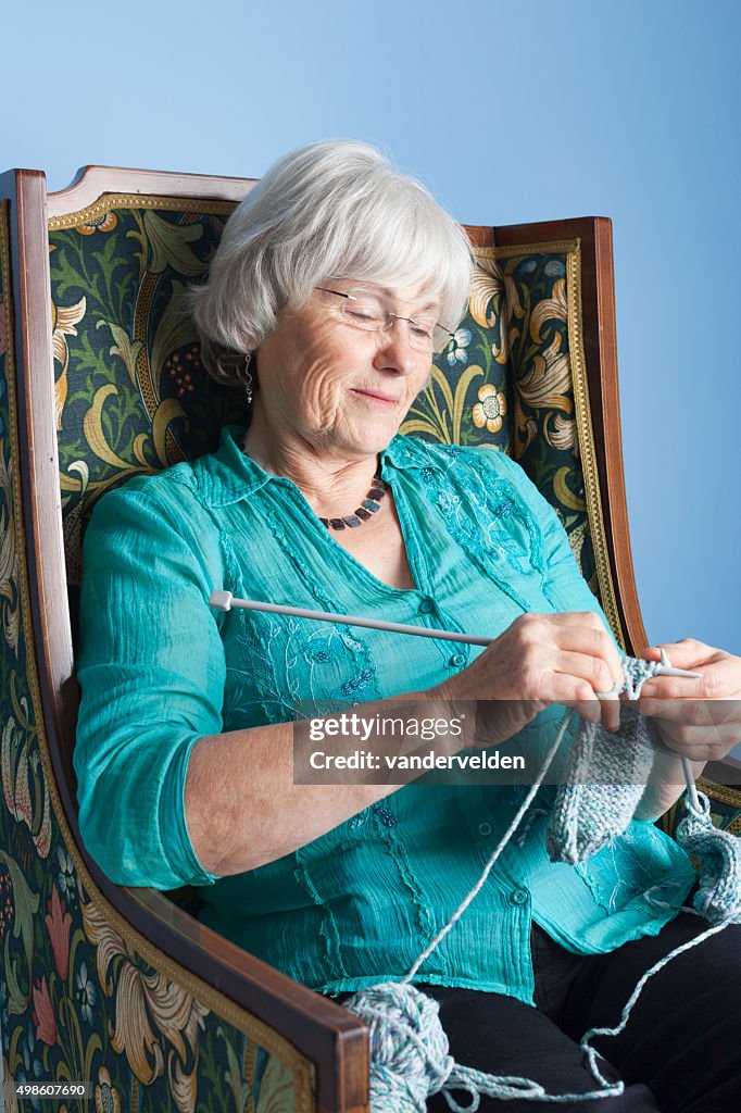 Grannie Knitting In Her Favourite Chair