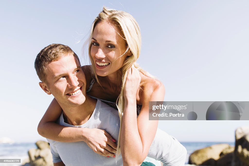 Happy couple in love playing no the beach.