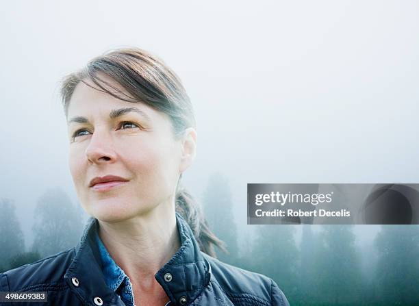 female looking to horizon in rural scene - farmer silhouette stock pictures, royalty-free photos & images