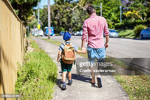 Father and son walking to school Father and son walking to school