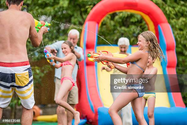 people enjoying pool party - inflatable playground stock pictures, royalty-free photos & images