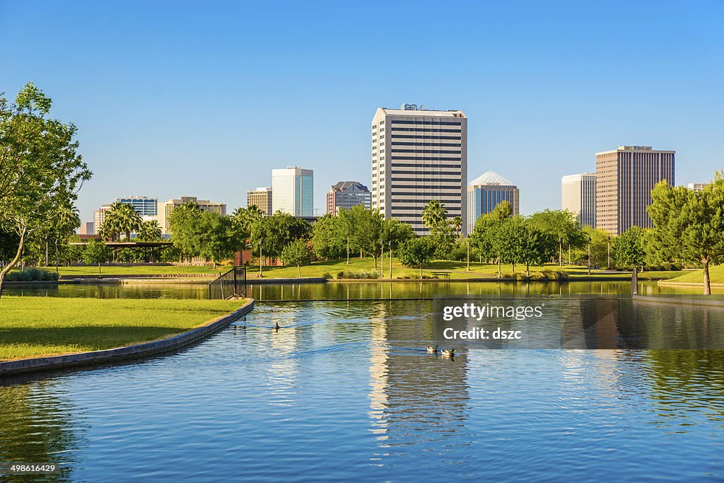 Phoenix Arizona skyline - park, pond, and skyscrapers cityscape background