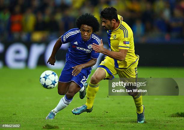 Willian of Chelsea chases the ball down with Omri Ben Harush of Maccabi Tel-Aviv during the UEFA Champions League Group G match between Maccabi...