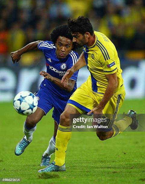 Willian of Chelsea chases the ball down with Omri Ben Harush of Maccabi Tel-Aviv during the UEFA Champions League Group G match between Maccabi...