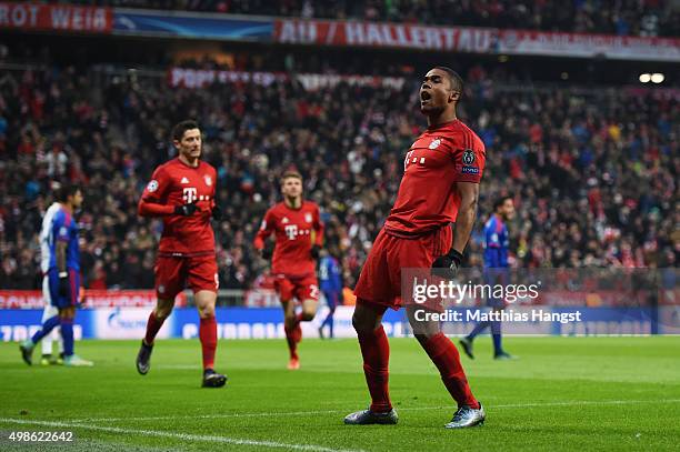 Douglas Costa of Bayern Muenchen celebrates scoring his teams opening goal during the UEFA Champions League group F match between FC Bayern Munchen...