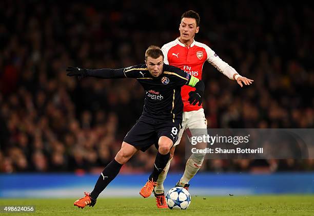 Domagoj Antolic of Dinamo Zagreb holds off Mesut Oezil of Arsenal during the UEFA Champions League match between Arsenal FC and GNK Dinamo Zagreb at...