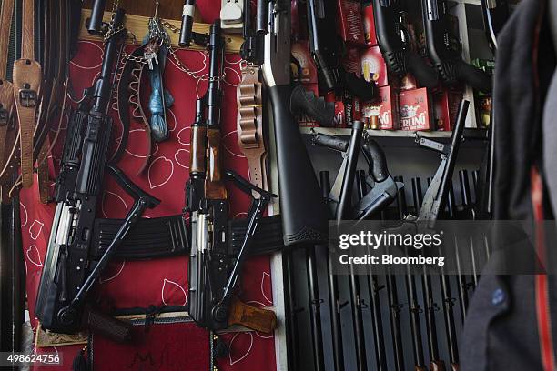 Shotguns, air rifles, and Kalashnikov rifles are displayed for sale in a gun stall at a market in Kabul, Afghanistan, on Wednesday, Oct. 21, 2015....