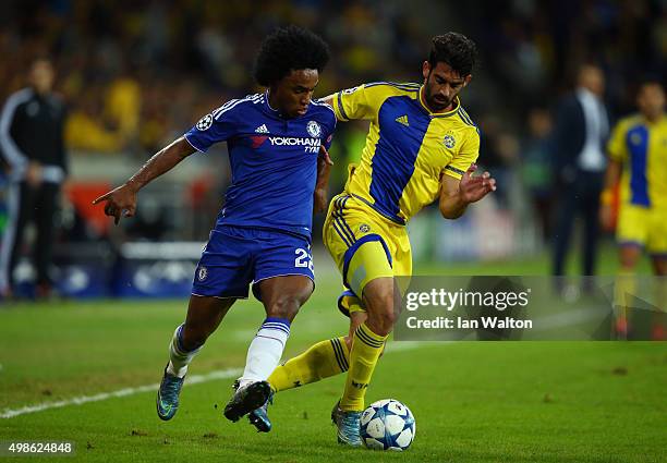 Willian of Chelsea chases the ball down with Omri Ben Harush of Maccabi Tel-Aviv during the UEFA Champions League Group G match between Maccabi...