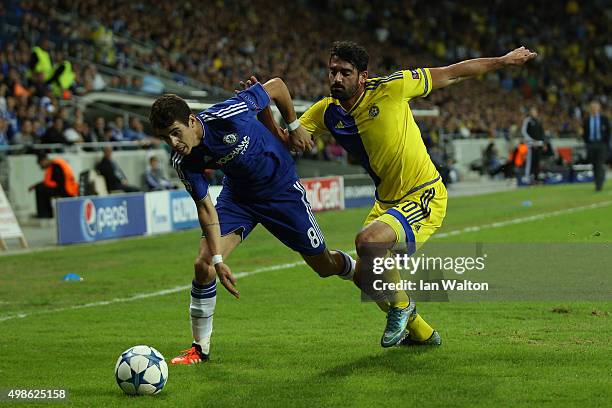 Oscar of Chelsea is challenged by Omri Ben Harush of Maccabi Tel-Aviv during the UEFA Champions League Group G match between Maccabi Tel-Aviv FC and...