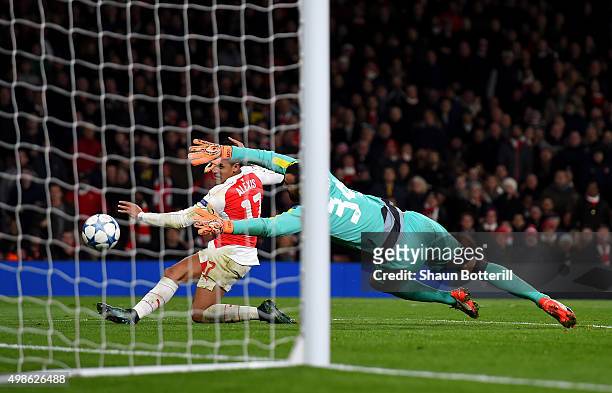Alexis Sanchez of Arsenal scores his side's third goal past Eduardo of Dinamo Zagreb during the UEFA Champions League match between Arsenal FC and...