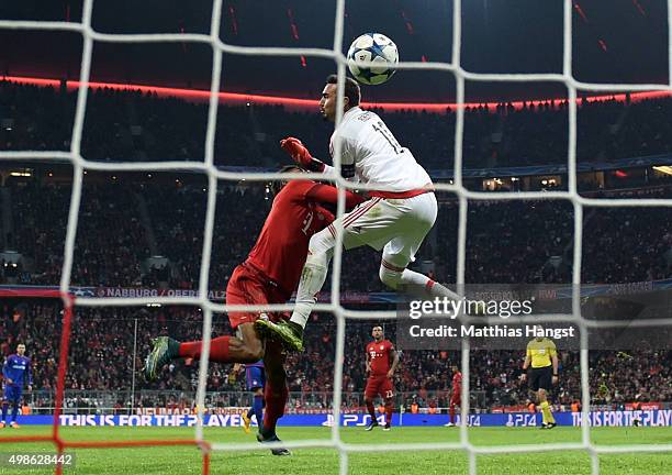 Kingsley Coman of Bayern Muenchen clashes with Roberto of Olympiacos as he scores his teams fourth goal during the UEFA Champions League group F...