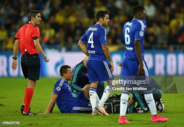 John Terry of Chelsea receives treatment before leaving the field on a stretcher during the UEFA Champions League Group G match between Maccabi...