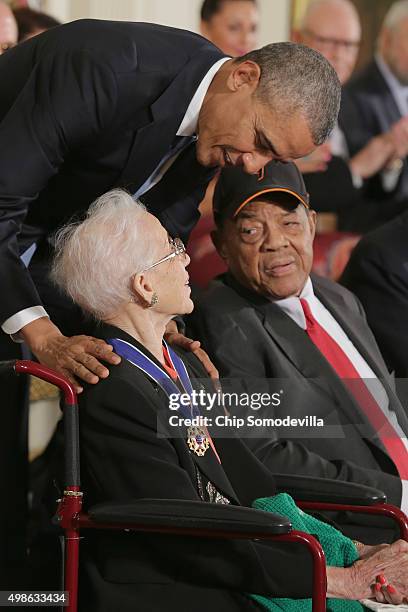 President Barack Obama presents pioneering NASA mathematician Katherine Johnson with the Presidential Medal of Freedom as Willie Mays look on during...