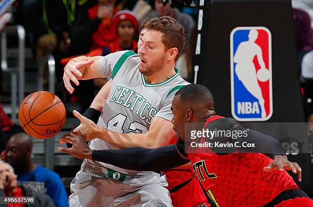Paul Millsap of the Atlanta Hawks knocks the ball out of the hands of David Lee of the Boston Celtics at Philips Arena on November 24, 2015 in...
