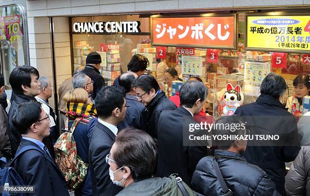 People queue up to purchase tickets for the one billion yen "Year-end Jumbo Lottery" as the first tickets go on sale in Tokyo on November 25, 2015....