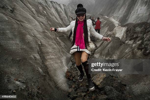 Chinese tourist walks in the tongue of Glacier 1 at the base of the 7,556 m Mount Gongga, known in Tibetan as Minya Konka on November 10, 2015 in...