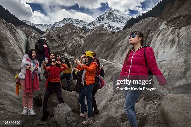 Chinese tourists walk in the tongue of Glacier 1 at the base of the 7,556 m Mount Gongga, known in Tibetan as Minya Konka on November 13, 2015 in...