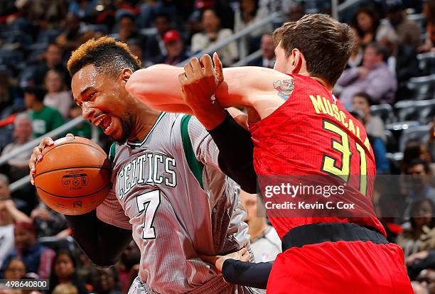 Jared Sullinger of the Boston Celtics drives against Mike Muscala of the Atlanta Hawks at Philips Arena on November 24, 2015 in Atlanta, Georgia....