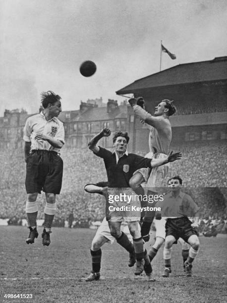Ivor Broadis of England attempts to head the ball but is beaten to it by Bobby Brown, the Scotland goalkeeper, during the 195152 British Home...