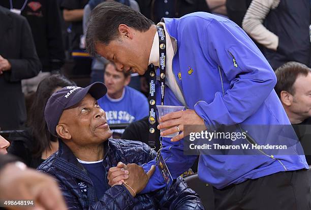 Co founder of Yahoo, Jerry Yang chats with former NFL star Ronnie Lott prior to the start of an NBA basketball game between the Los Angeles Lakers...