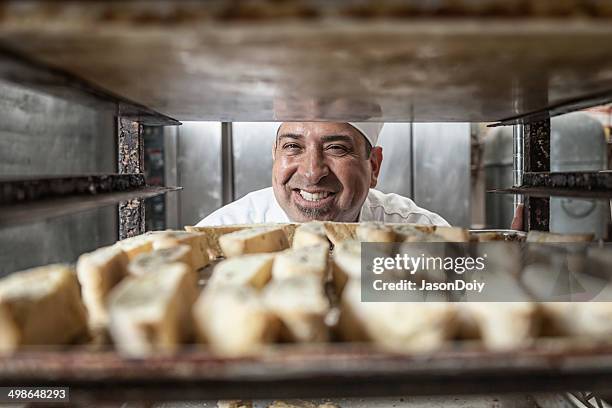 baker with fresh biscotti - baker stock pictures, royalty-free photos & images