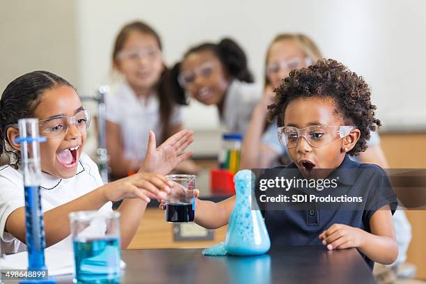 excited students doing chemistry experiement in science class at school - funny black girl stock pictures, royalty-free photos & images